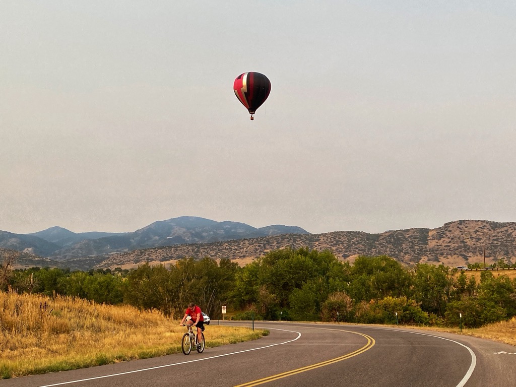 A hot-air balloon above the road at Chatfield State Park